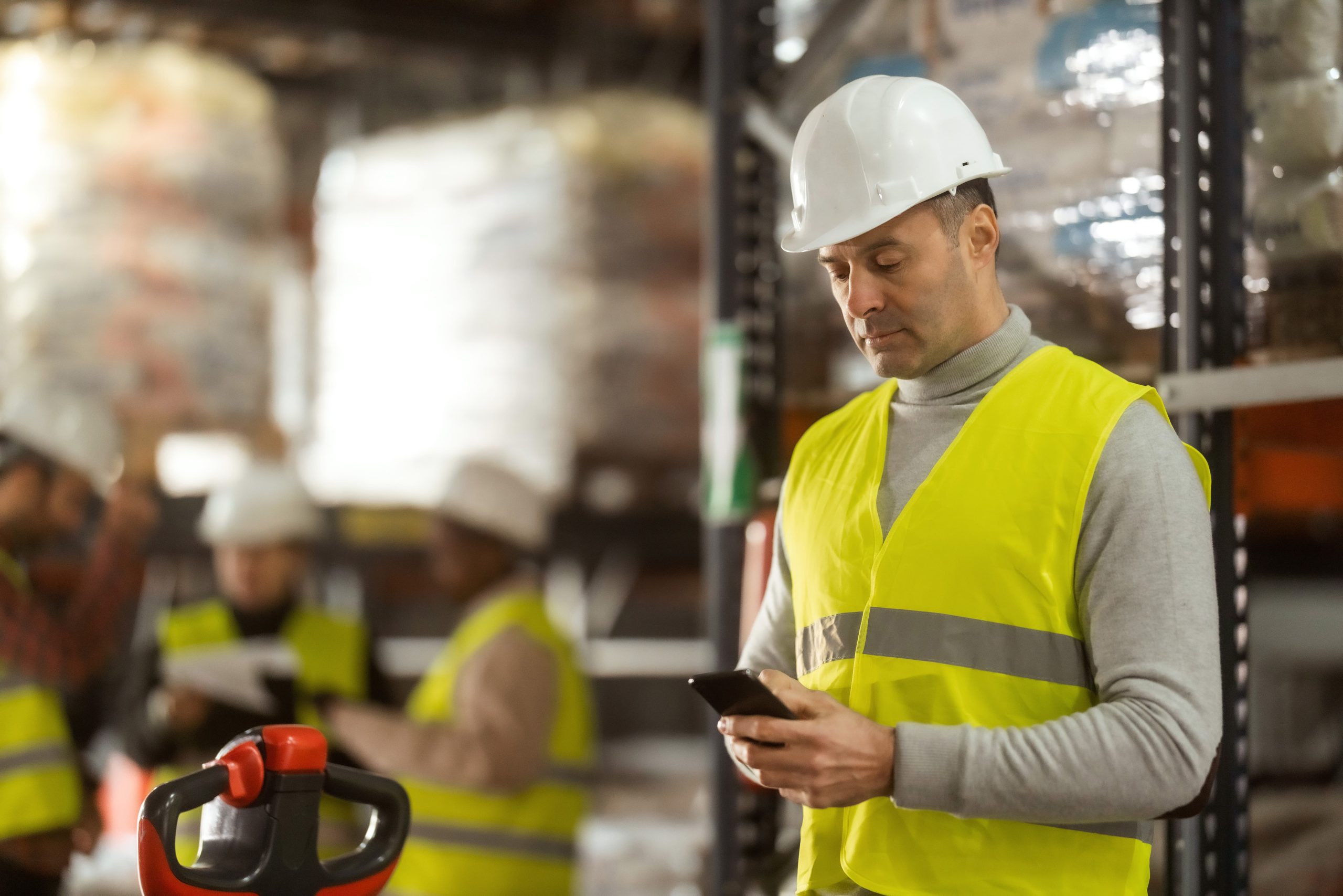 construction worker using mobile phone to perform equipment inspection and safety check